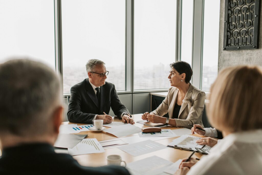pexels-photo-7433853-7433853 Business professionals engaged in a strategic meeting in a modern office setting with natural light.